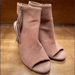 Size 8.5 open toed faux suede booties with zip up tassel. Slight wear shown.